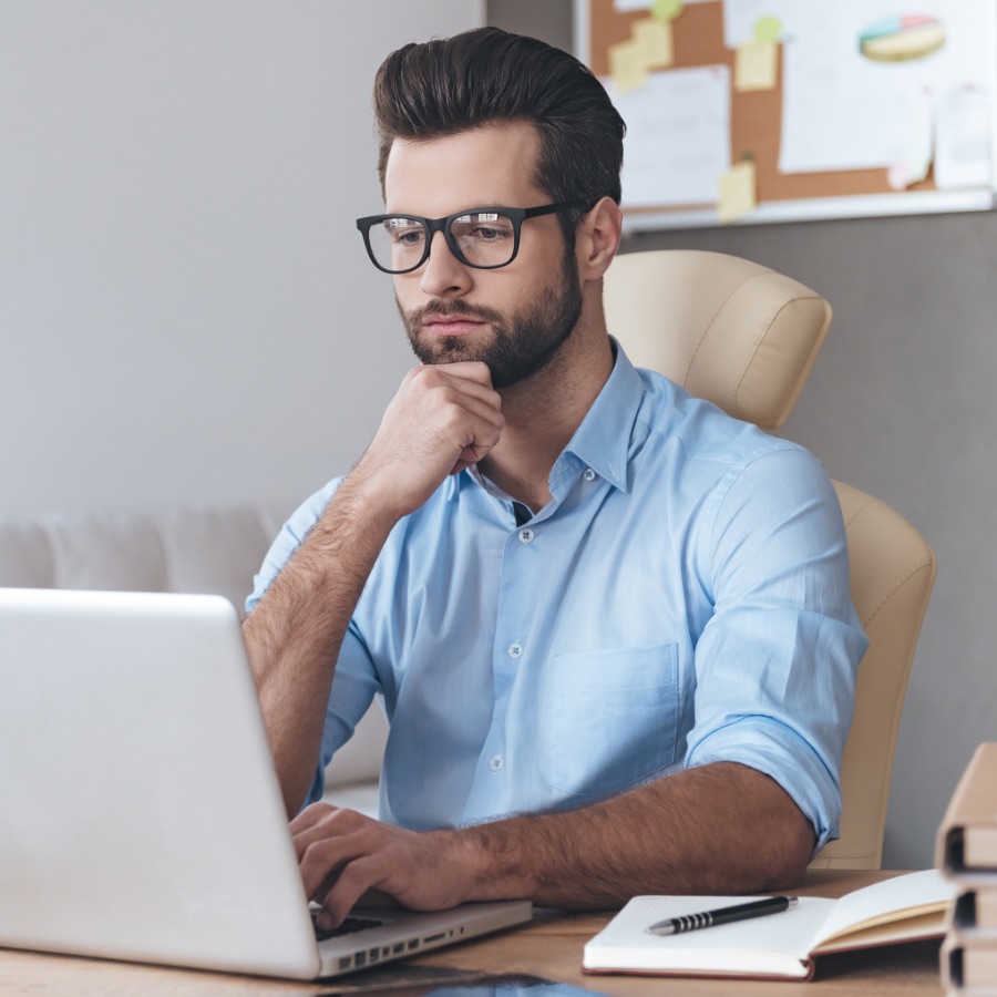 A NasBoard team member working at a laptop