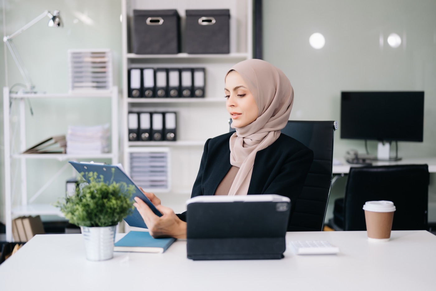 A NasBoard team member reviewing employment paperwork at her desk